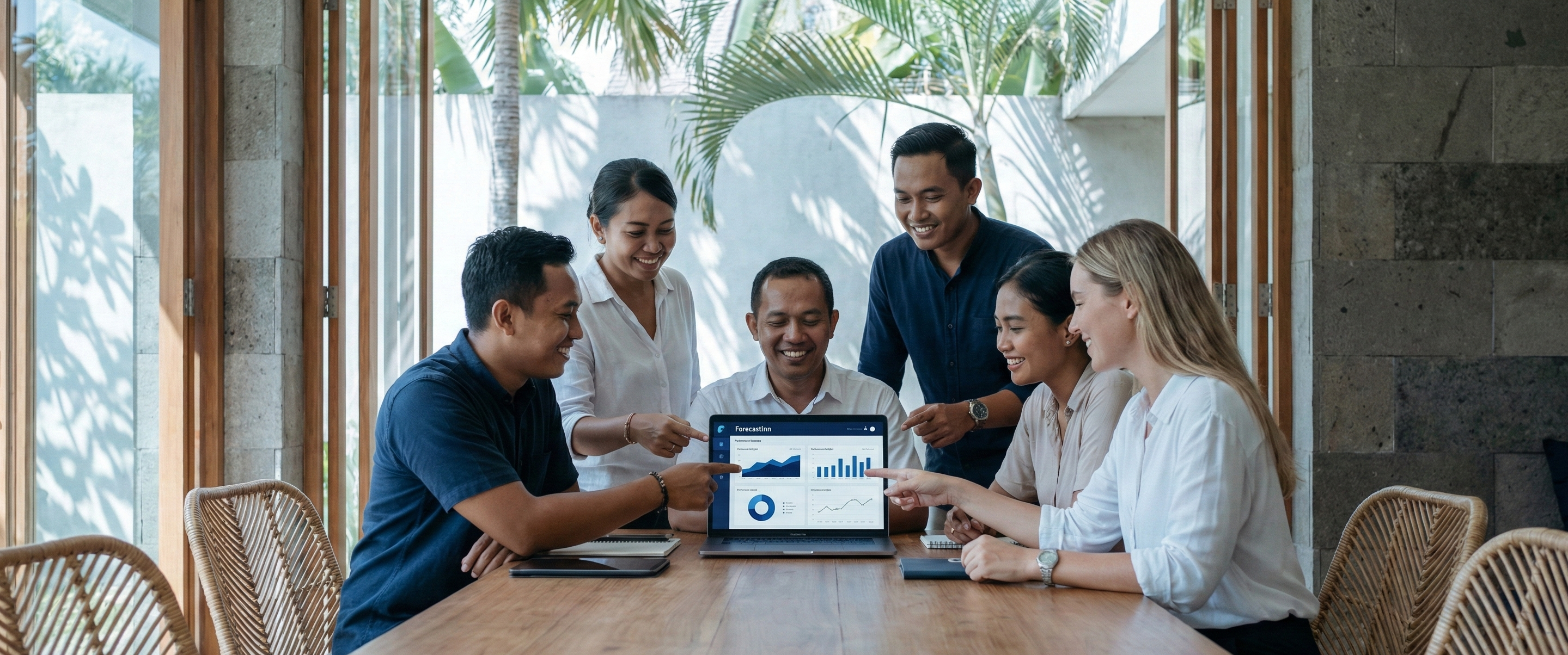 Revenue and eCommerce team in Bali reviewing the ForecastInn dashboard together